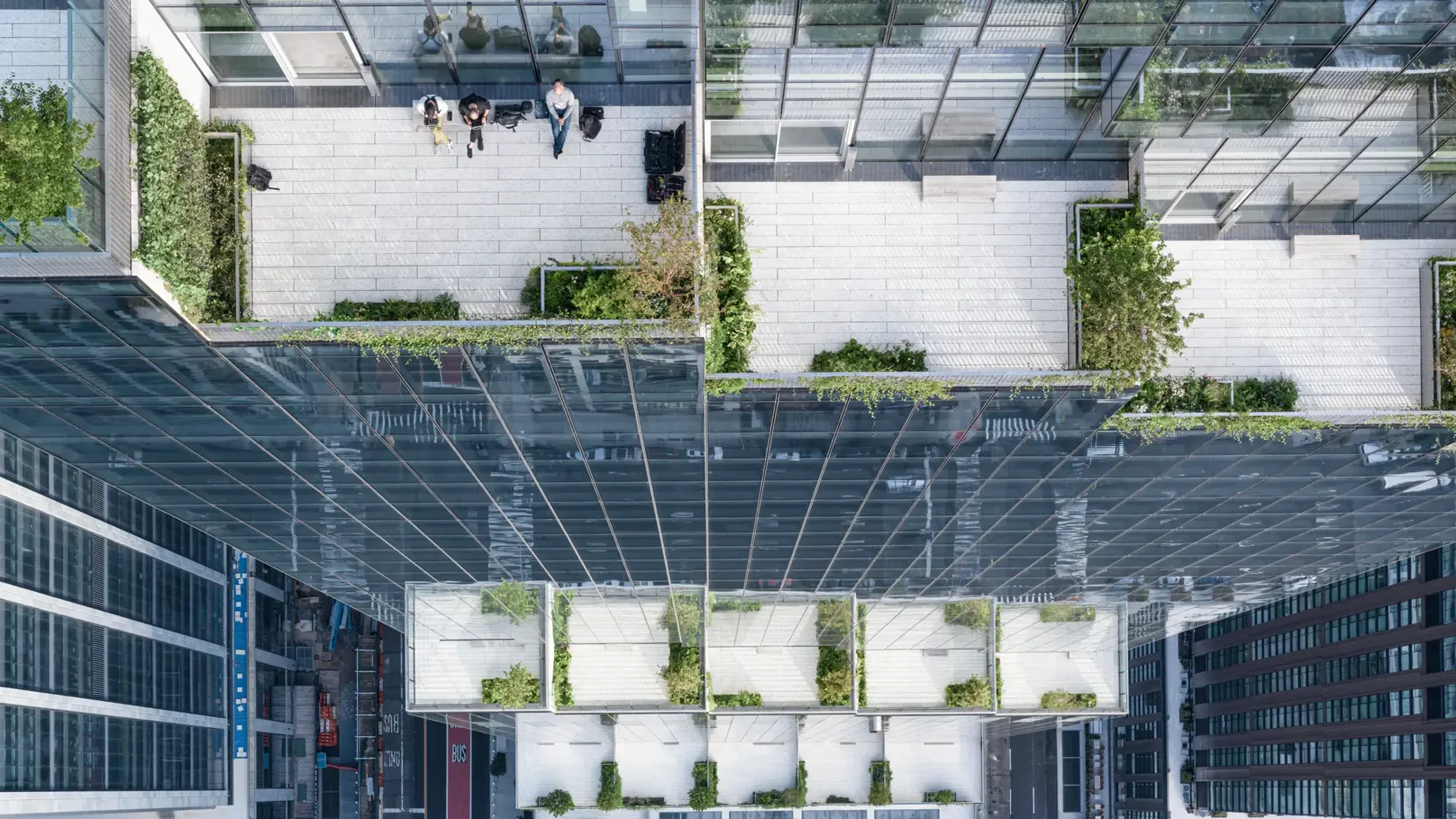 Aerial view of people seated in a communal terrace on top of a tall building