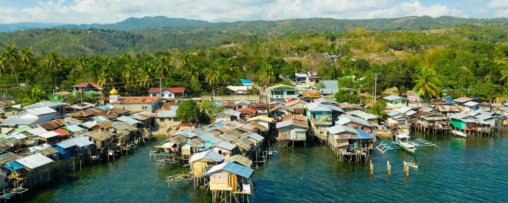 Wooden houses built on the river in a low socio-economic neighbourhood in an Asian city