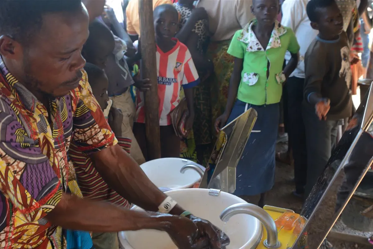 A person pouring a liquid into a cup.