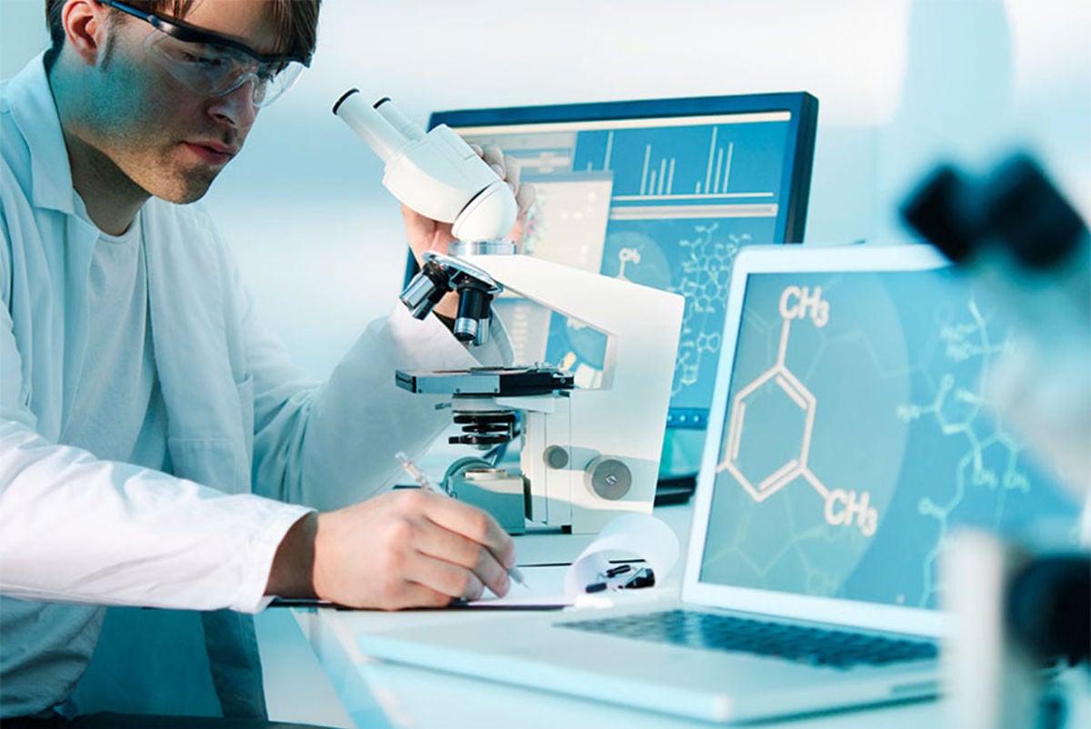 Scientist in a lab using a microscope